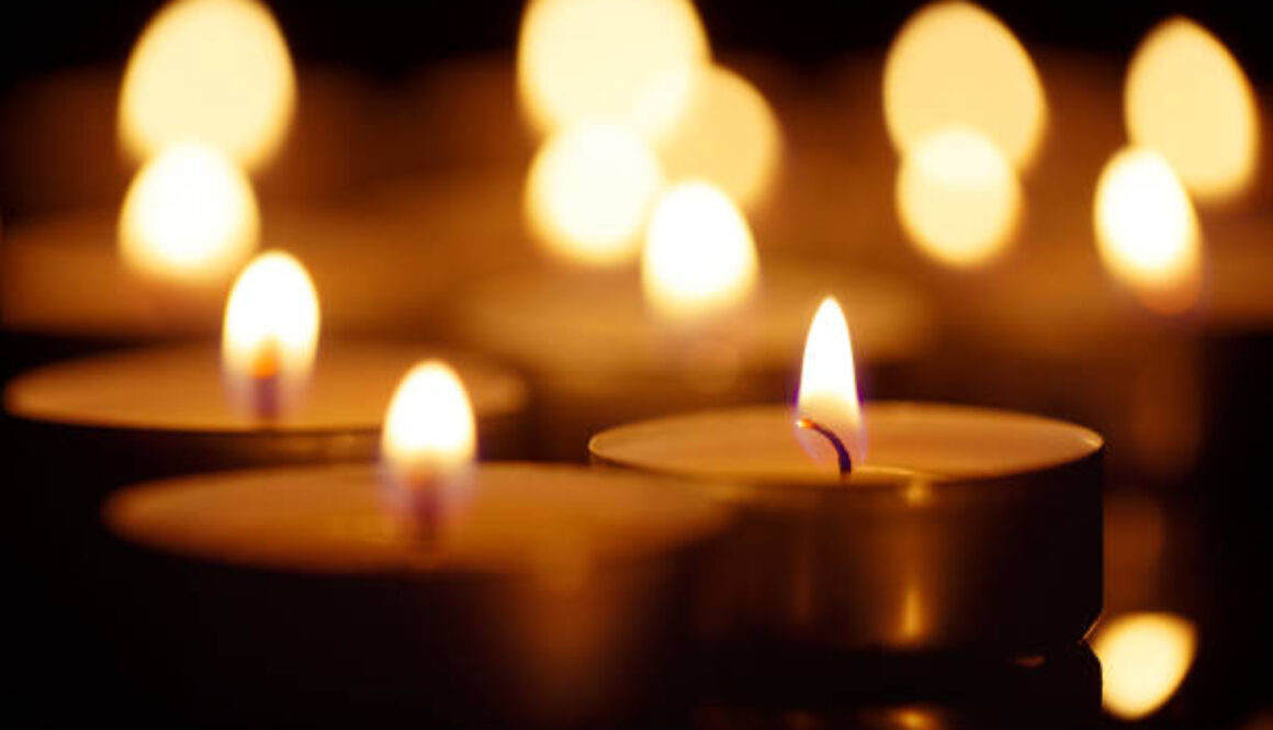 Burning candles on black background, shot with shallow depth of field