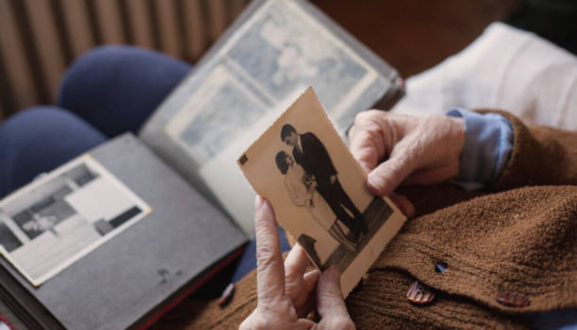 Senior woman looking at her wedding photo.