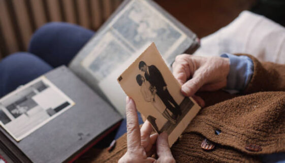 Senior woman looking at her wedding photo.